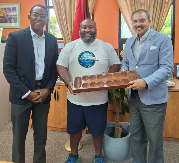L-R-Permanent-Secretary-Sean-Cenac-Mr.-Brian-Emmanuel-Sims-CEO-of-Got-Stamps-Travel-LLC-and-Hon.-H.-Charles-Fernandez-e1760718051680.jpeg